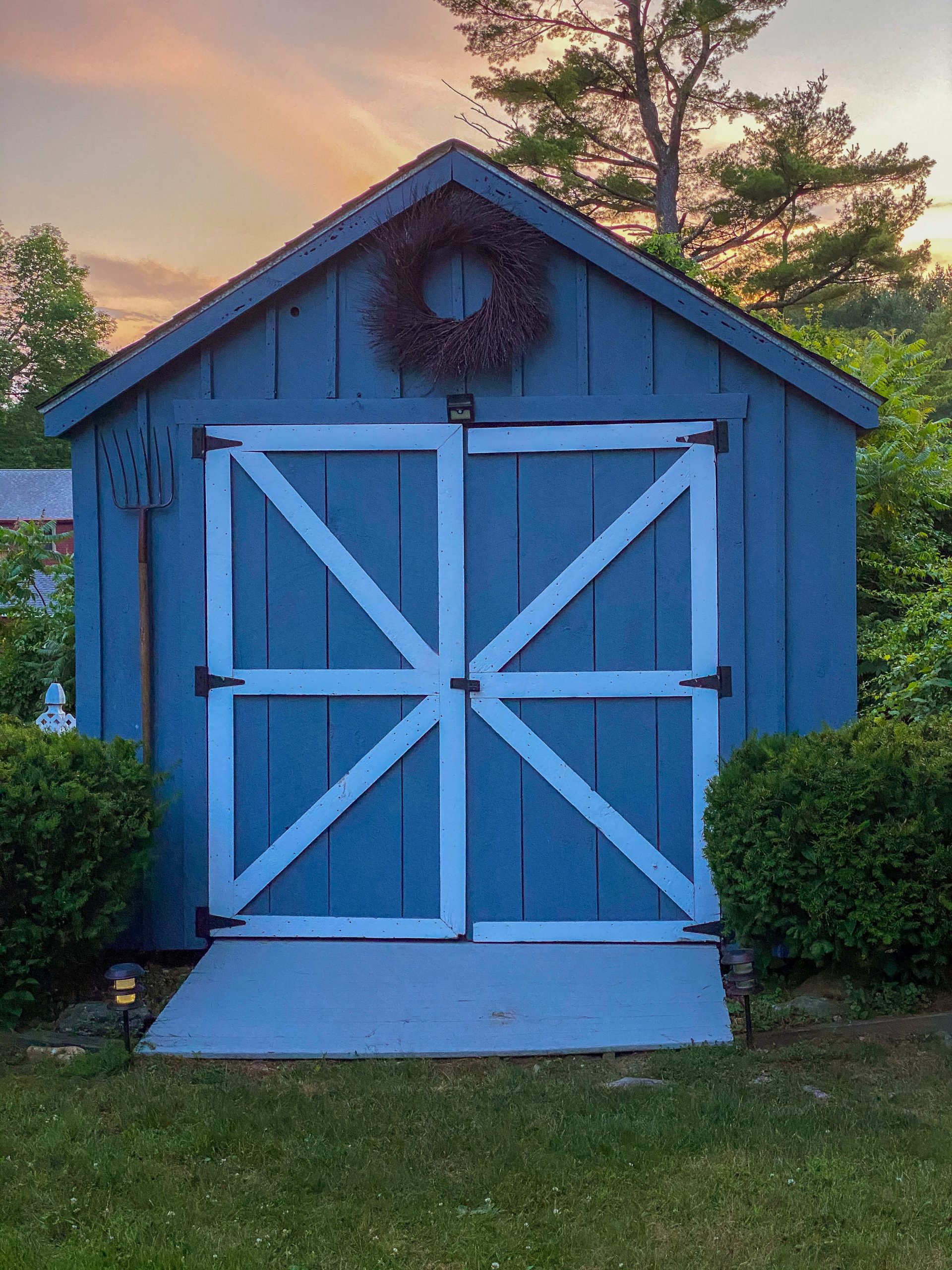 blue shed with sunset in background